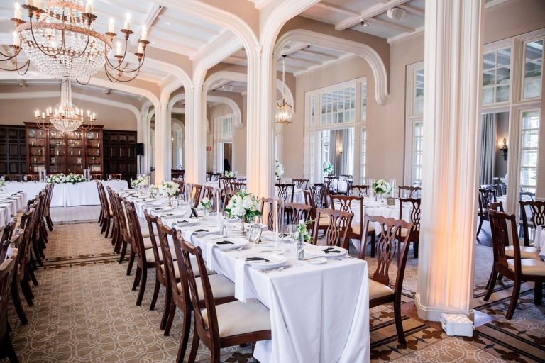 Arched hall with set tables and chandeliers