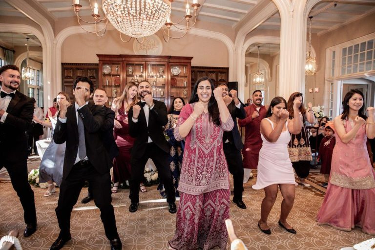 Group performing synchronized dance with arms raised
