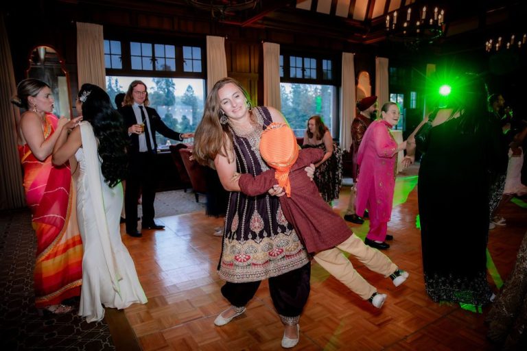 Guest spinning joyfully on dance floor in sari
