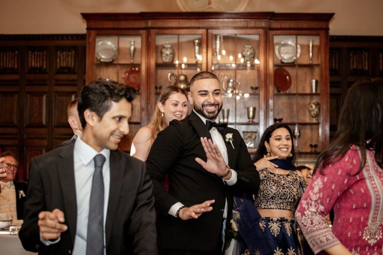 Guests dancing together in colorful attire celebrating