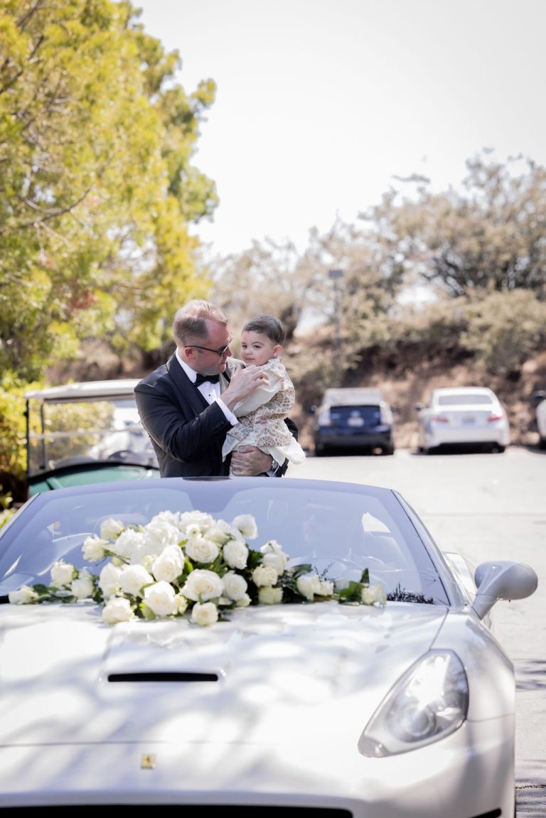 Sports car decorated with white florals on hood