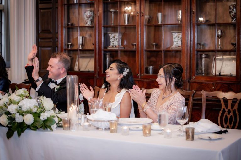 Head table guests clapping during reception toast