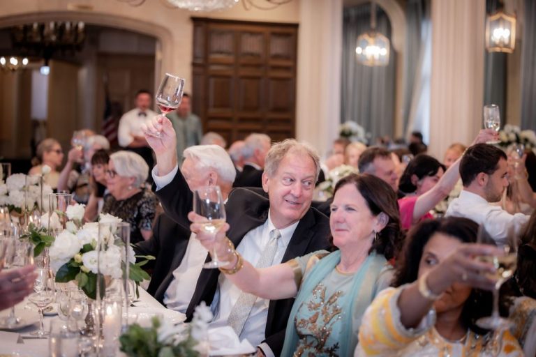 Guests raising glasses in toast at reception