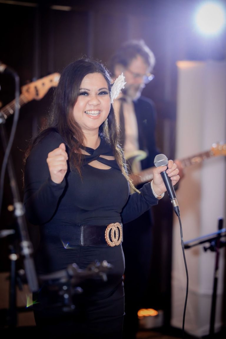 Female singer performing with microphone in black
