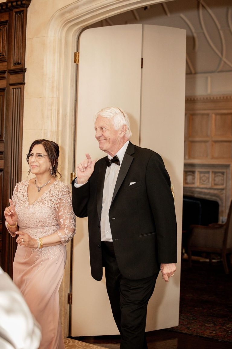 Couple walking through doorway into reception hall
