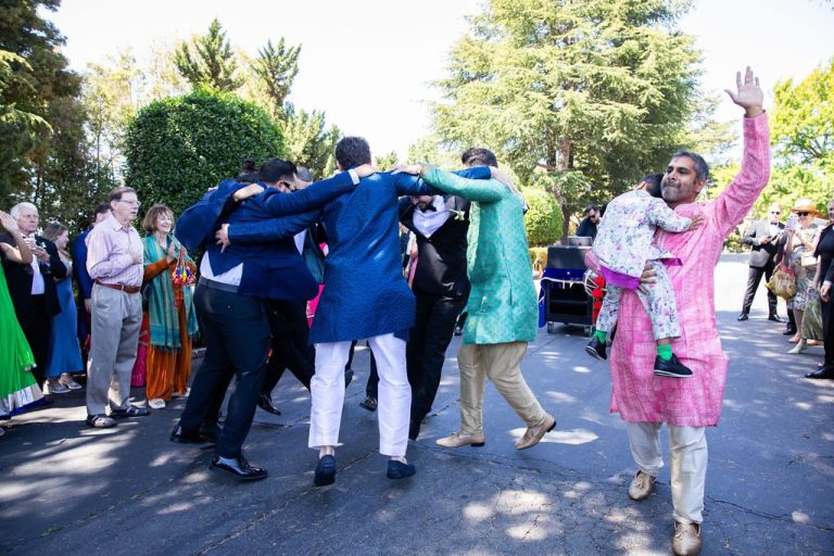 Group dancing joyfully during outdoor procession