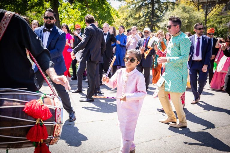 Child leads procession as guests dance behind