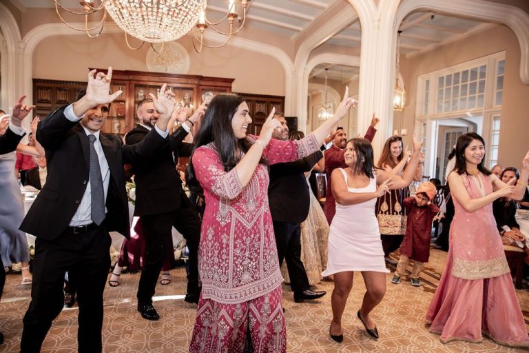 Group raising arms mid choreographed dance number