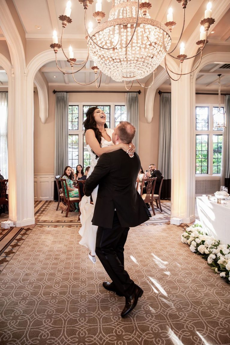 Groom lifting bride joyfully during first dance