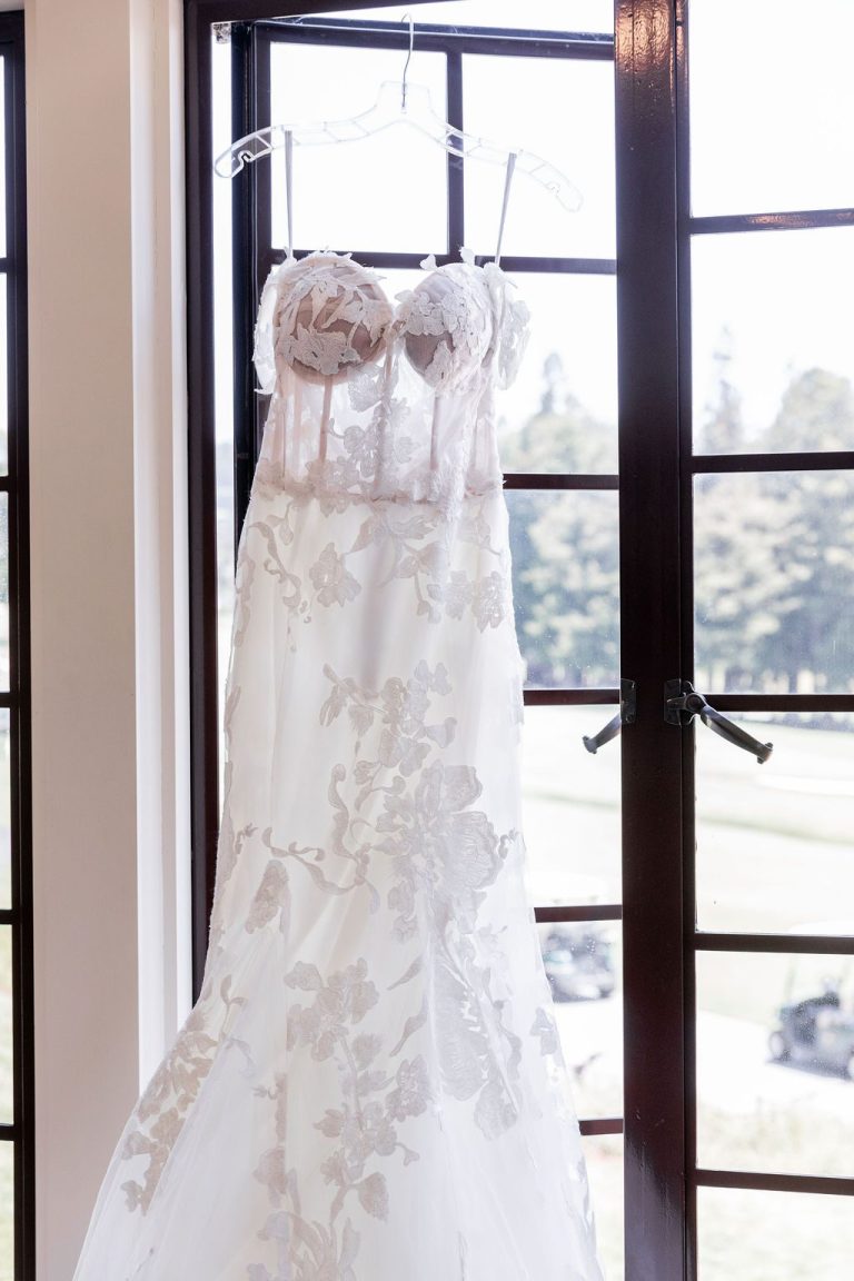 Close up of floral bodice on hanging wedding gown
