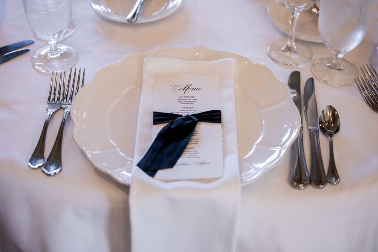 Elegant place setting with menu and navy ribbon