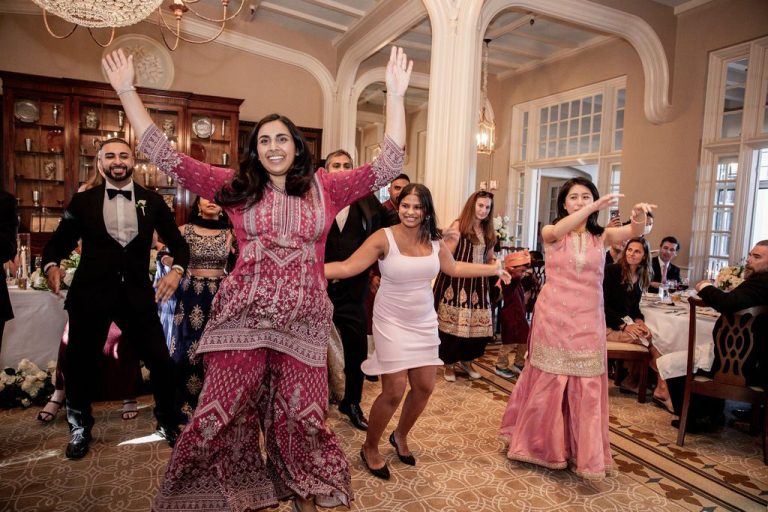 Guests dancing energetically in reception hall