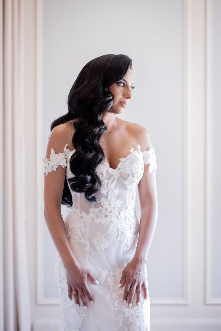 Bride glancing down with hair over shoulder indoors