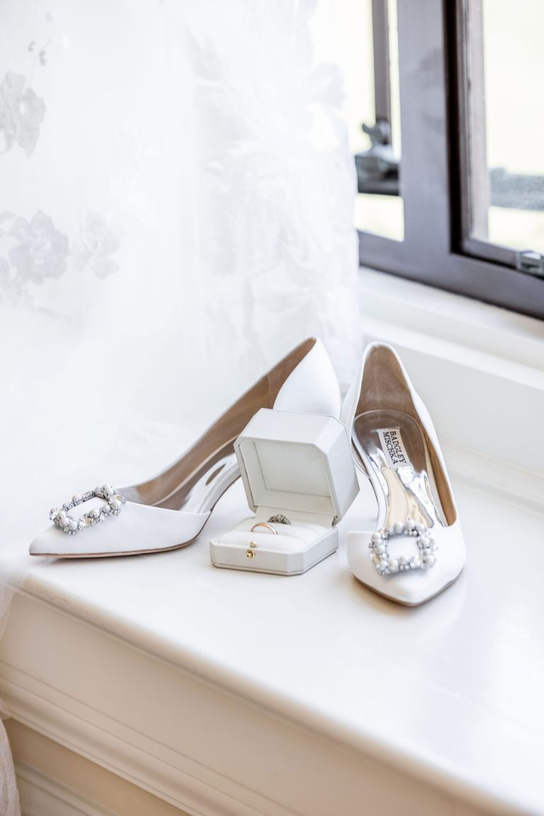 Jeweled heels and ring box on sunlit windowsill