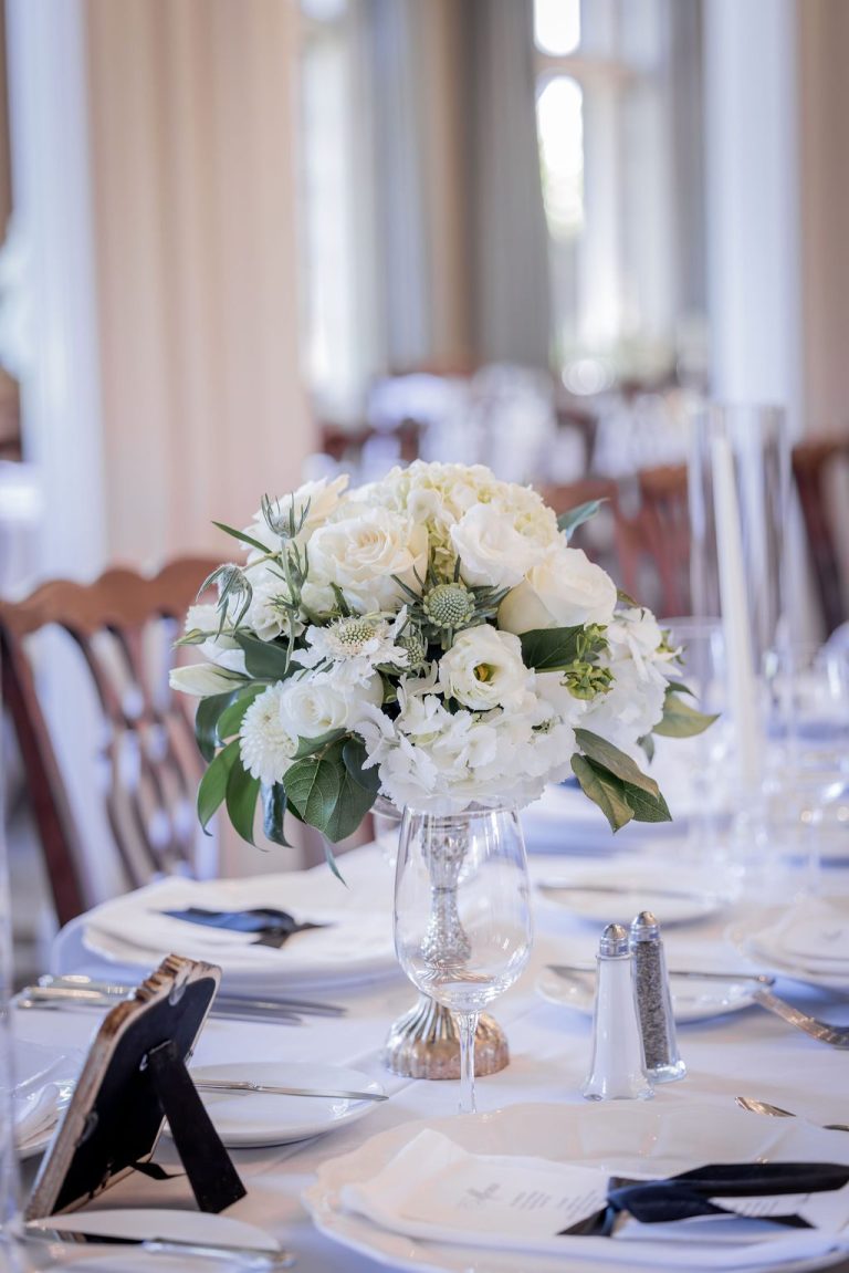 White floral centerpiece on set dining table