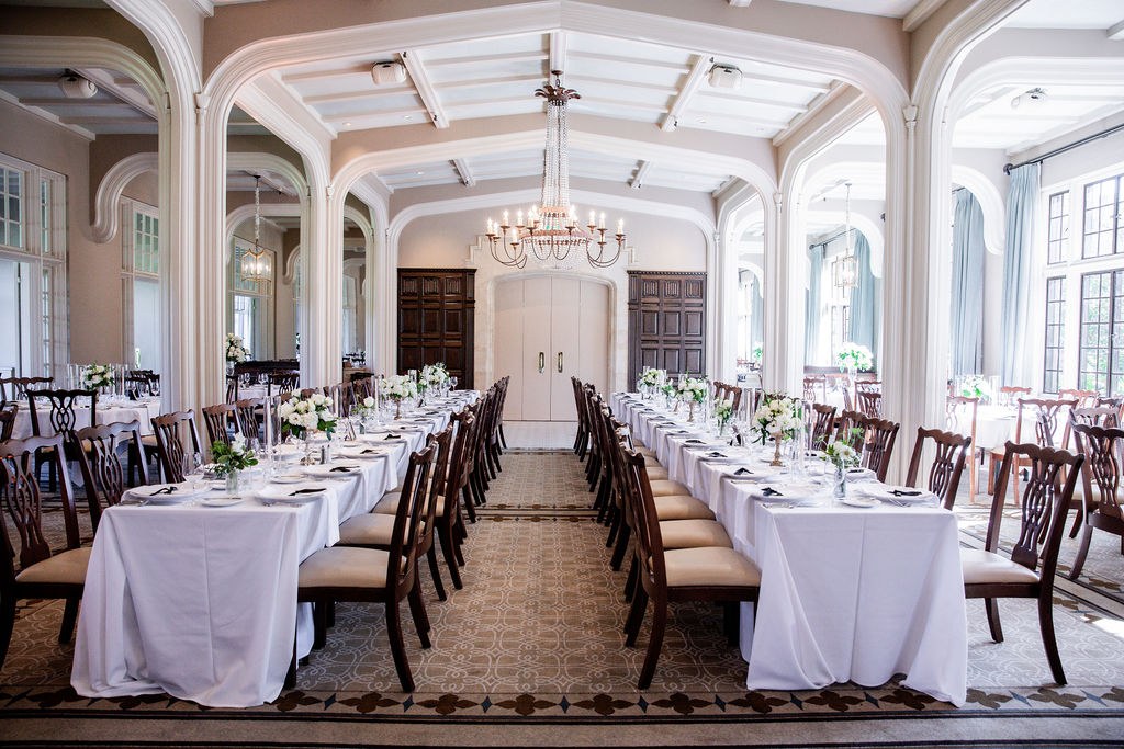 Long banquet tables in elegant arched reception hall