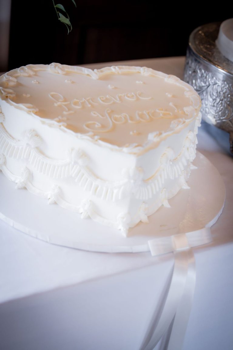 Heart shaped white cake with piped detailing