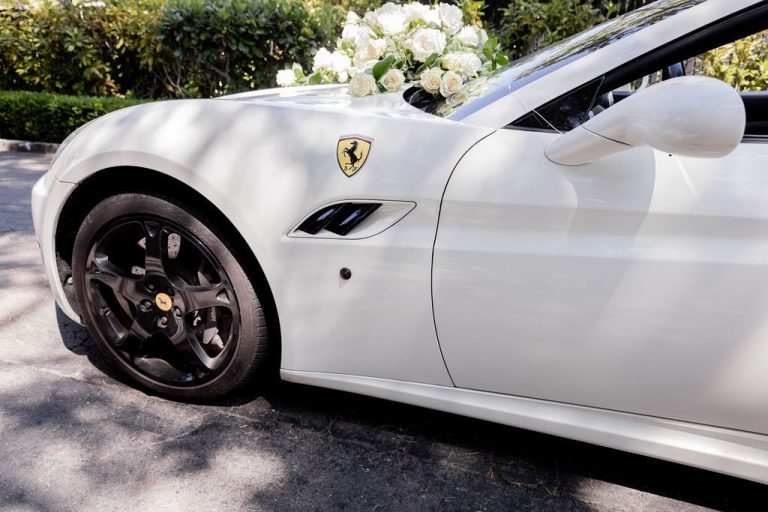 White sports car with floral decoration on hood