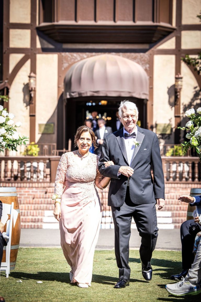 Couple processing down aisle from venue steps