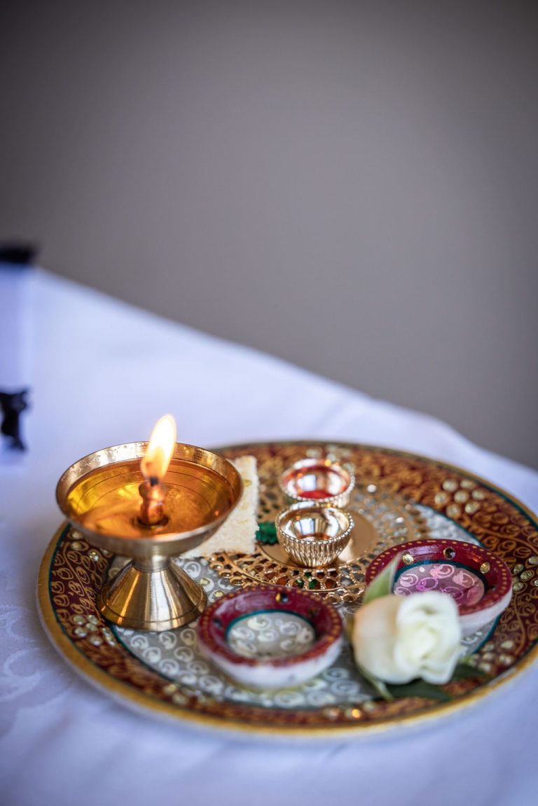 Traditional brass ceremony plate with lamp and offerings
