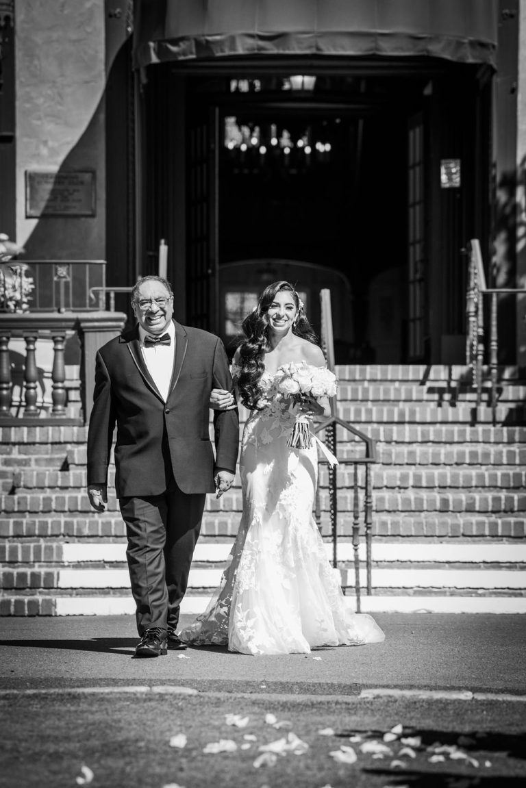 Black and white bride and escort walking down steps