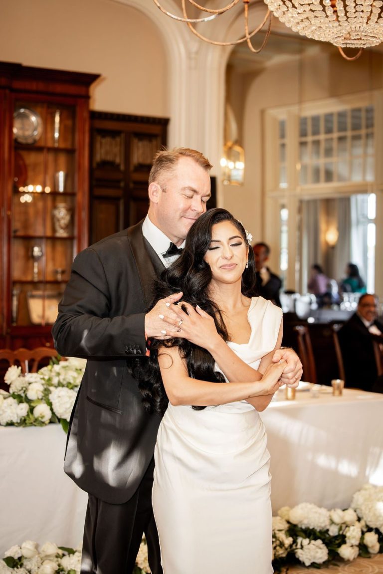 Groom holding bride tenderly during first dance