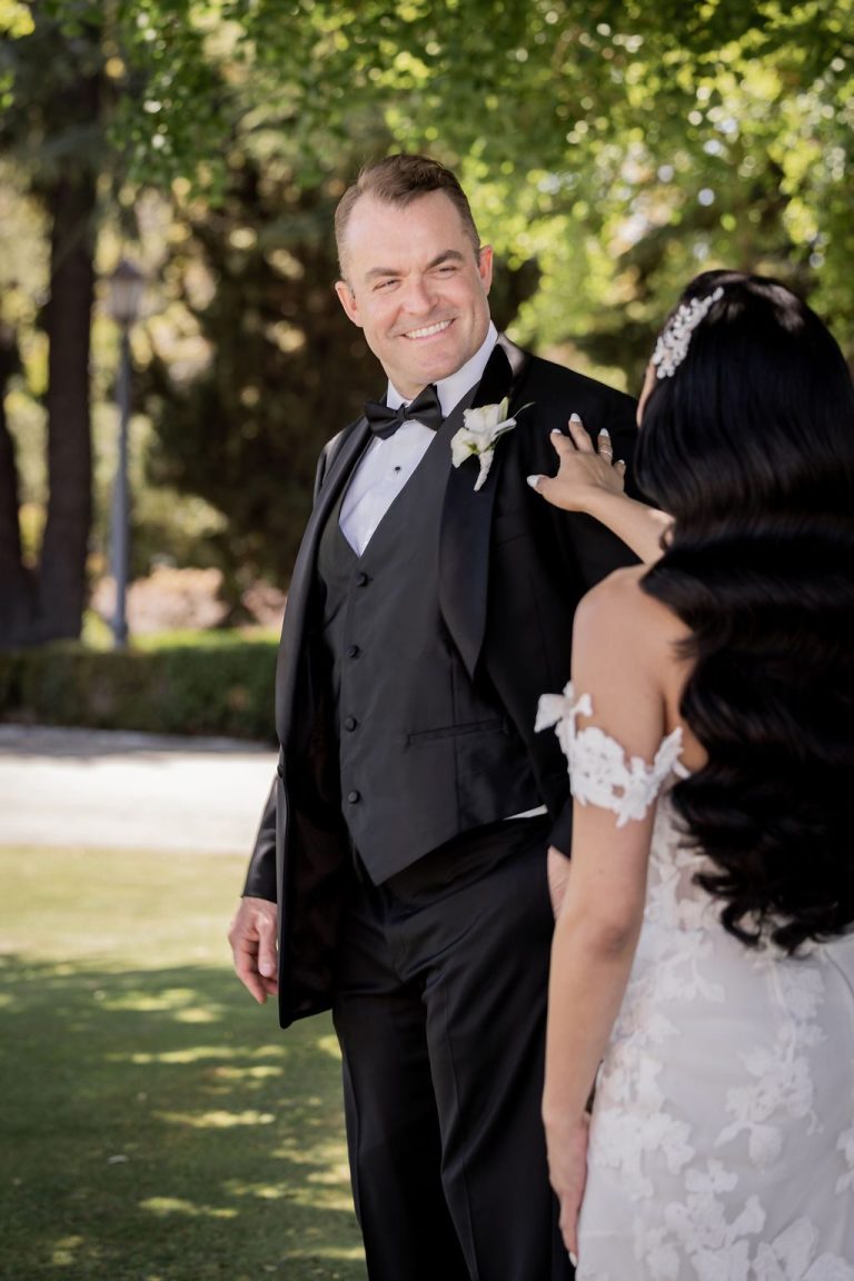 Groom smiling at bride's reveal during first look