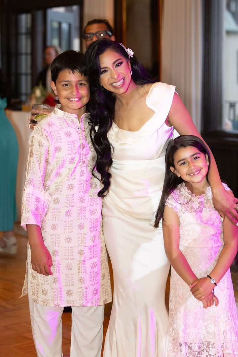 Bride posing with two children in festive attire