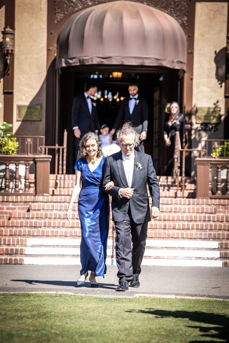 Couple descending venue steps into aisle