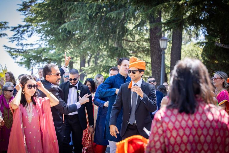 Guest in orange turban among crowd during outdoor procession