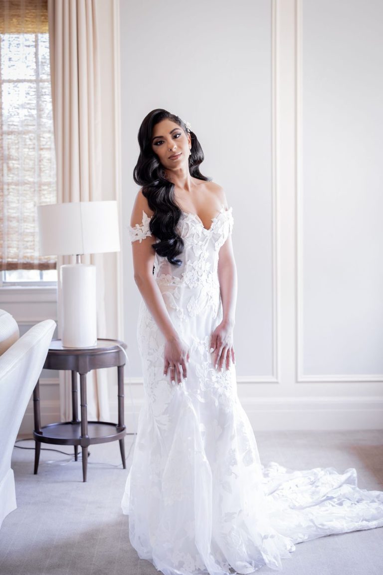 Bride alone in lace gown by lamp full length portrait