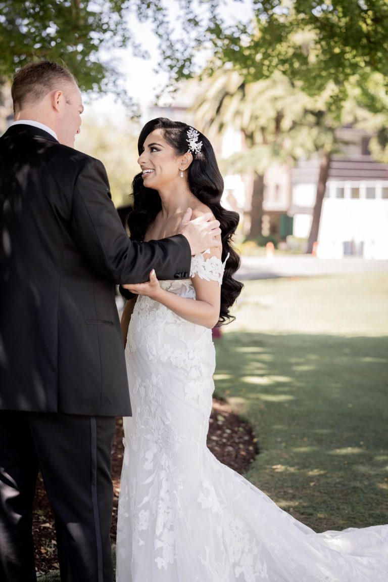 Bride and groom gazing at each other outdoors
