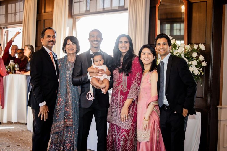 Family group portrait in wood paneled room