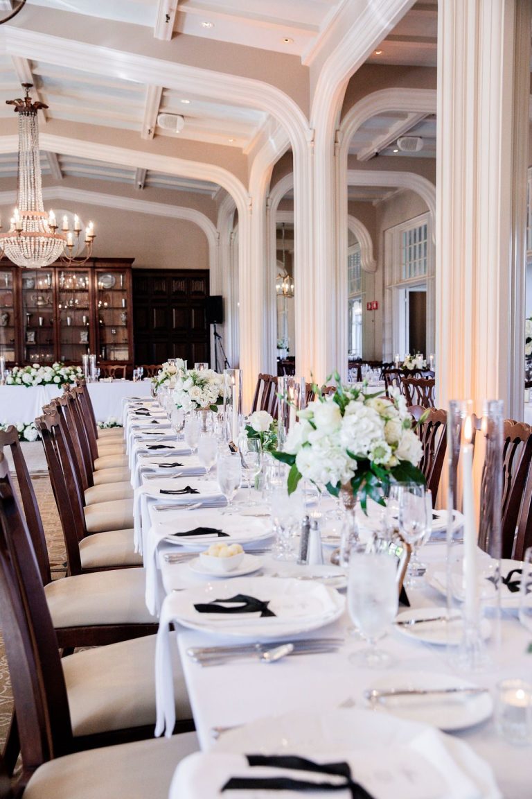 Long reception table with white florals and candlelight