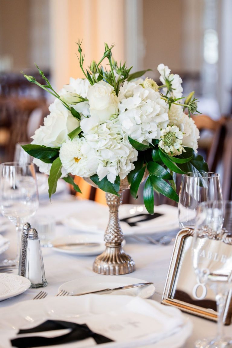 White floral centerpiece on set reception table