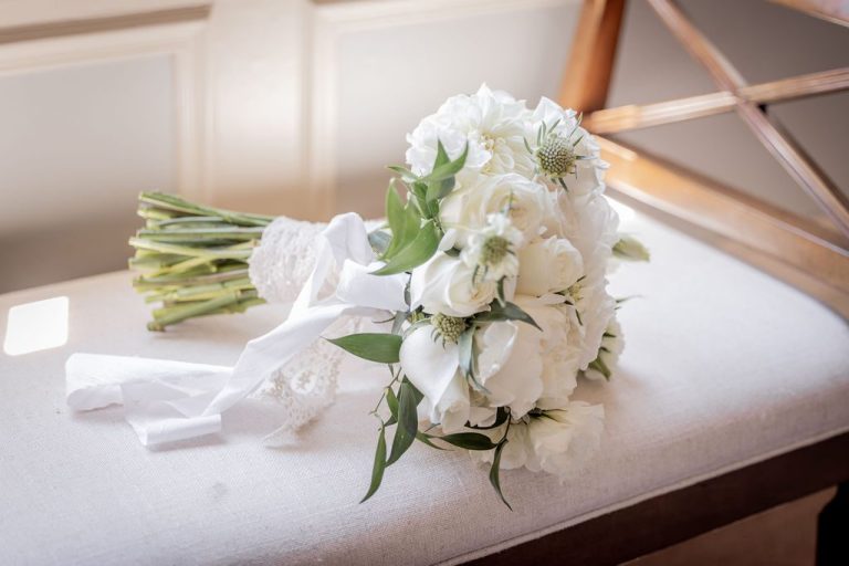Two white bouquets with calla lilies on table