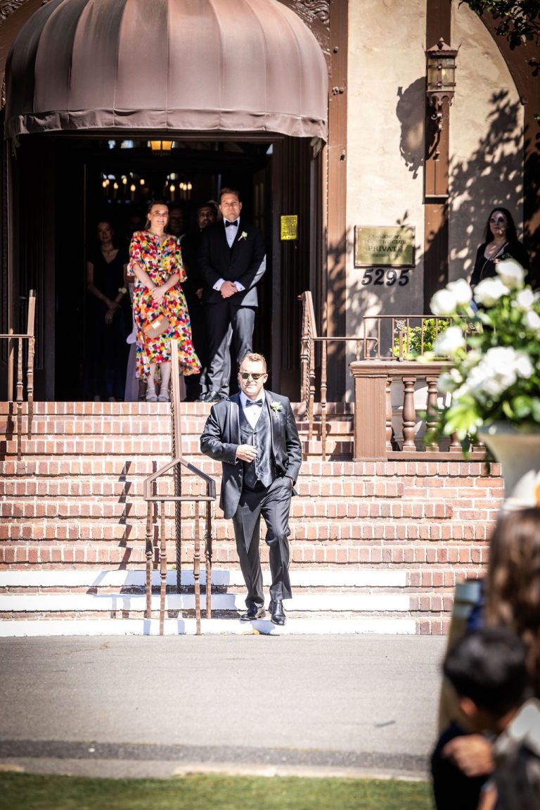Man descending venue steps into aisle, near duplicate