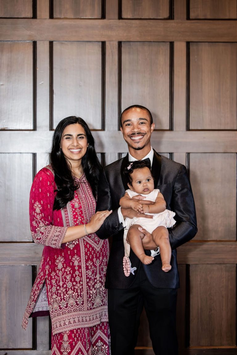 Couple holding baby posing indoors
