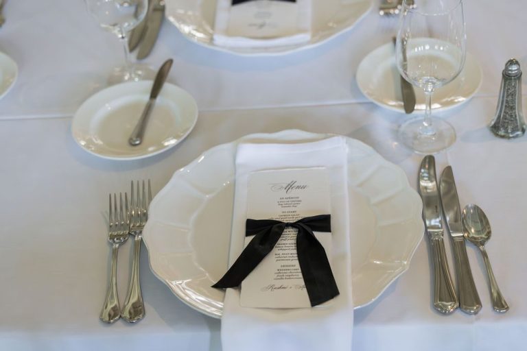 Elegant place setting with menu and black ribbon bow
