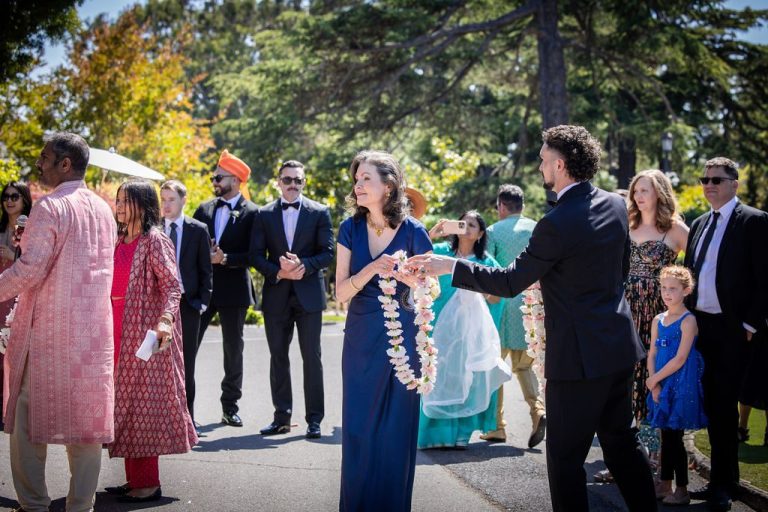 Guests exchanging garland across pathway during procession