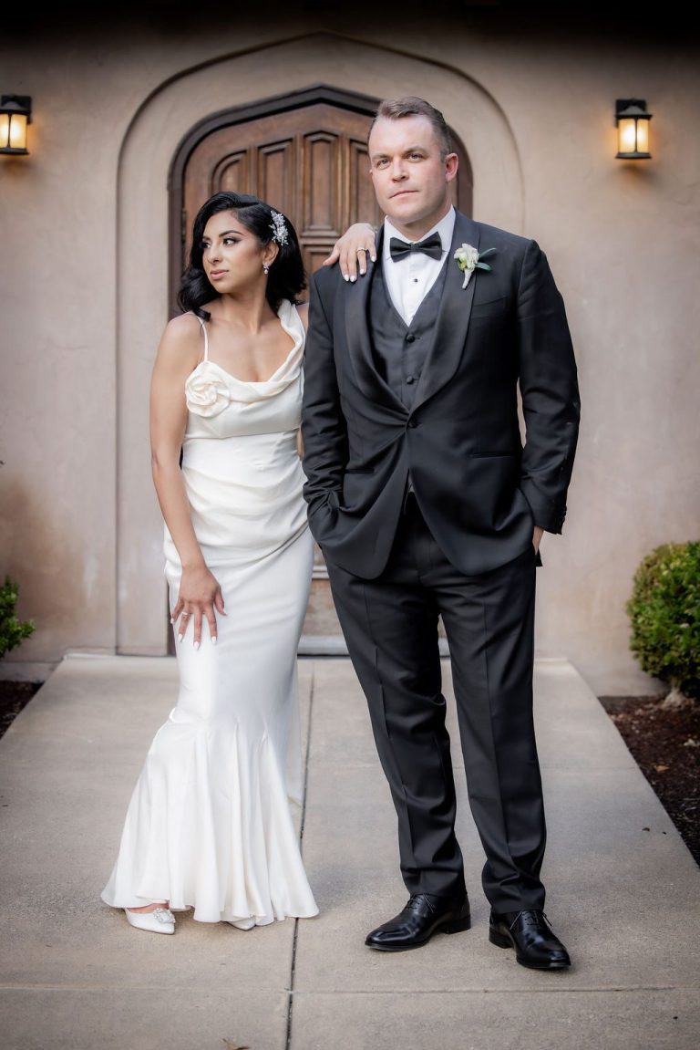 Elegant full length portrait of couple by doorway
