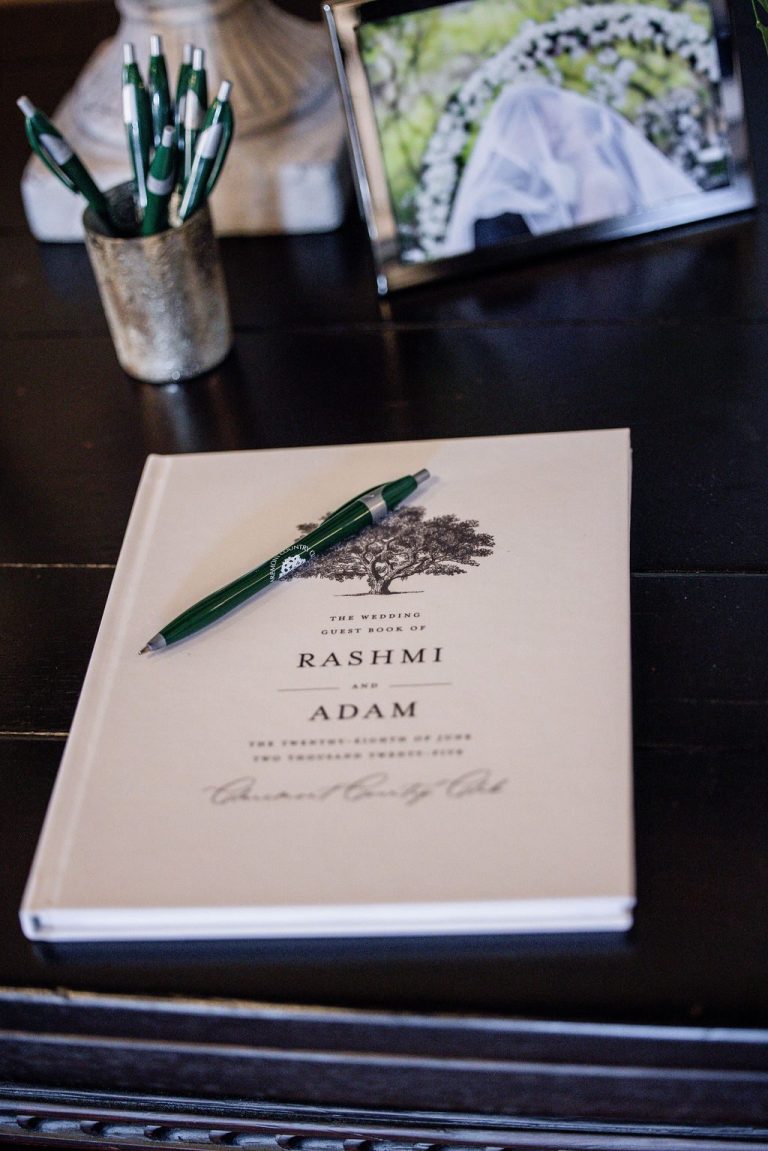 Guest book with couple names and green pen