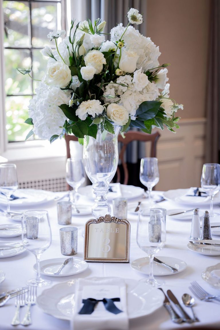 Tall floral centerpiece with framed table setting