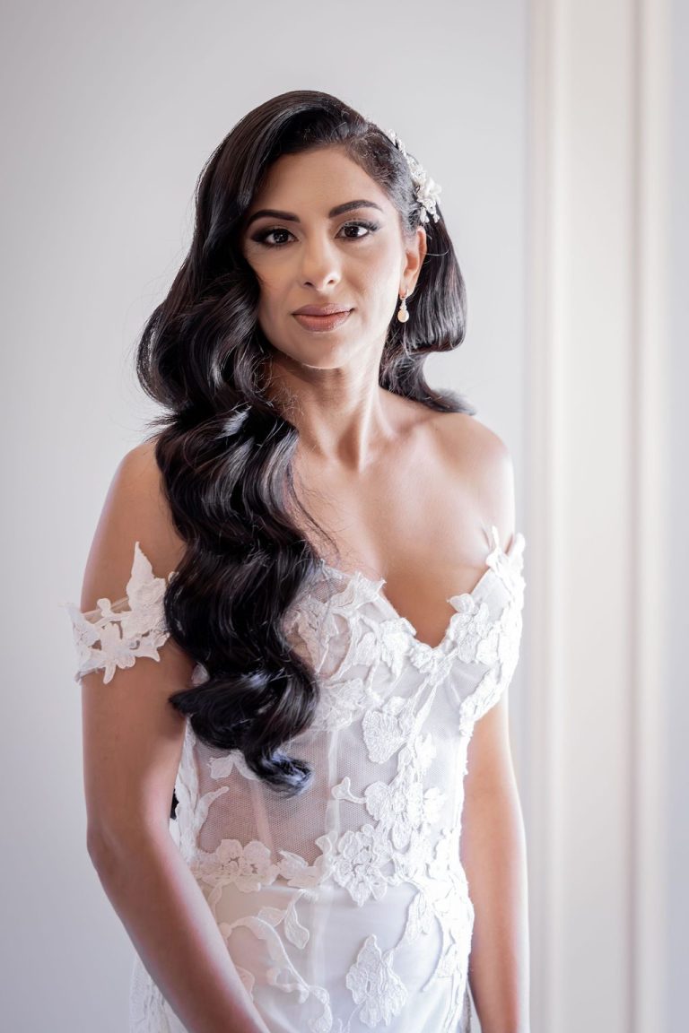 Bride with voluminous curls and sheer lace bodice