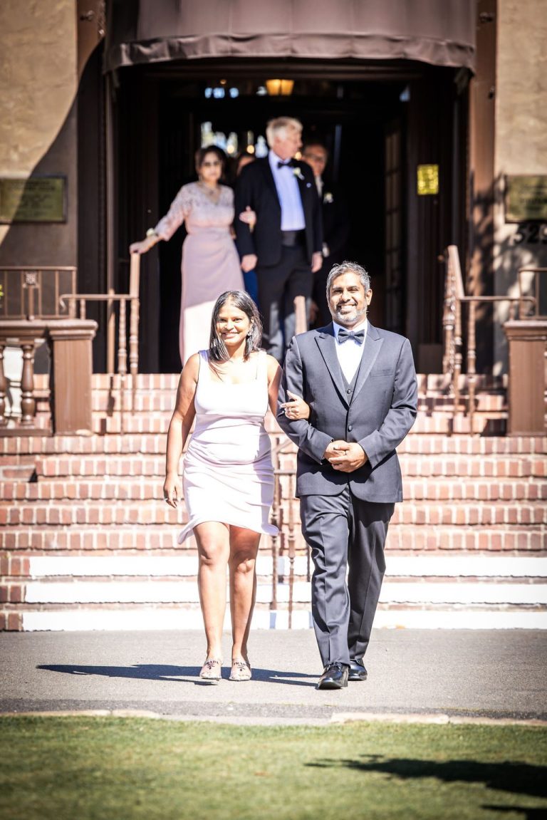 Couple walking down venue steps, near duplicate