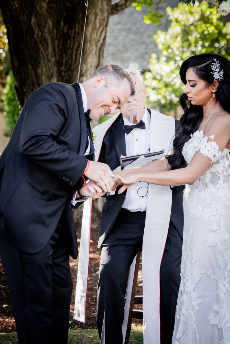 Groom kissing bride hand during ceremony ritual