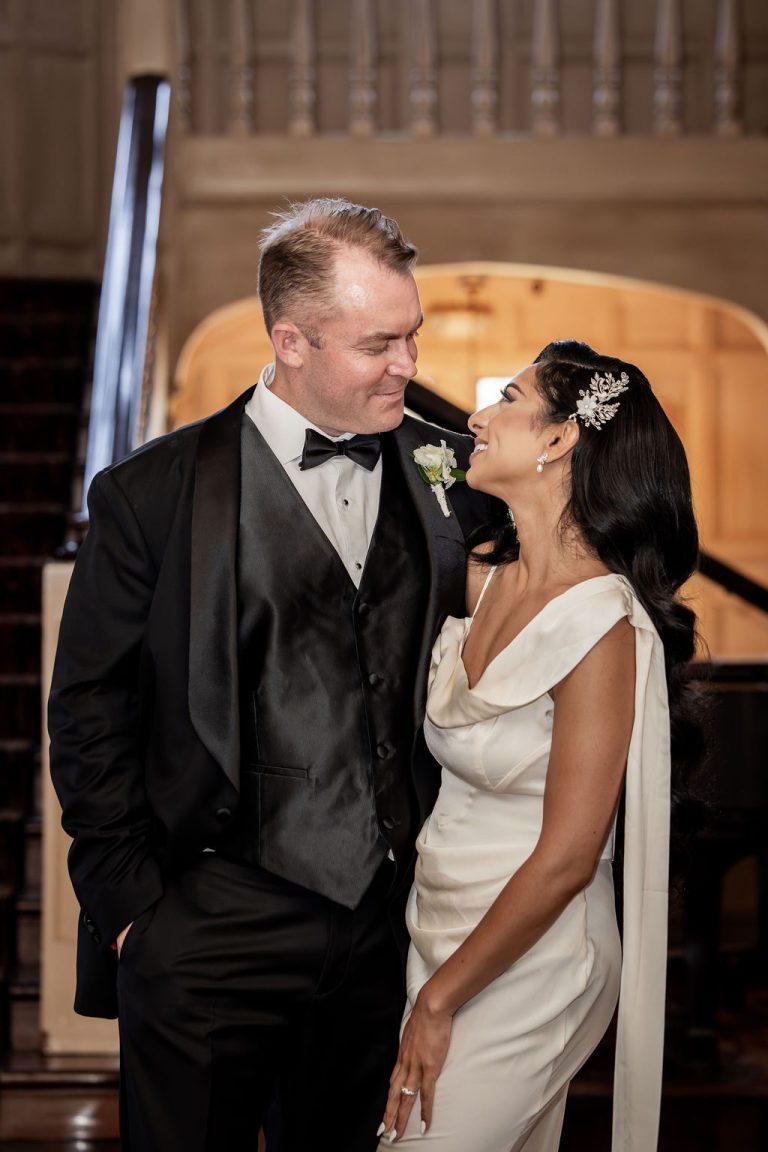 Bride and groom smiling close in evening wear